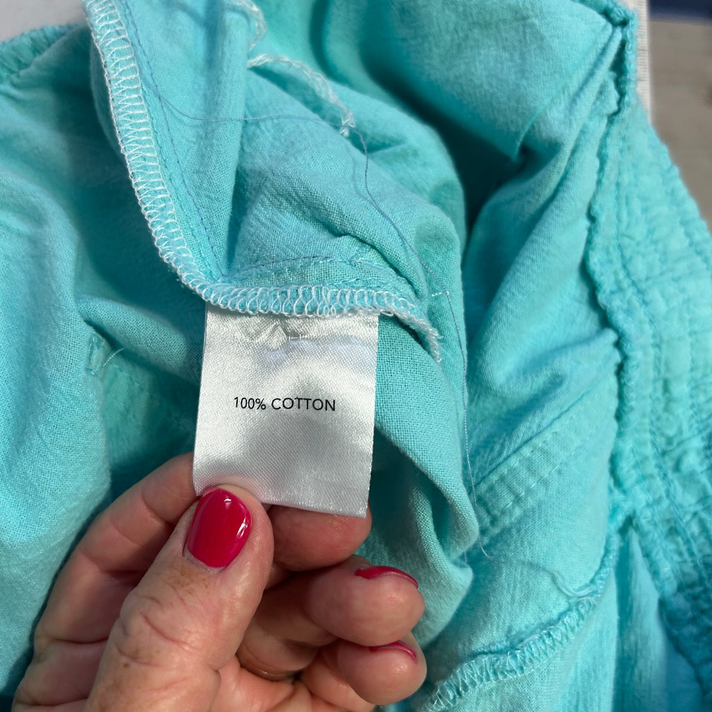 Light blue cotton garment label detail view