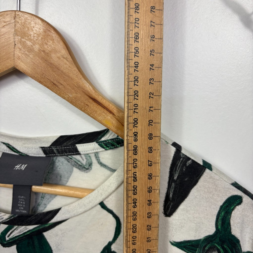 Cream and green graphic print top detail view