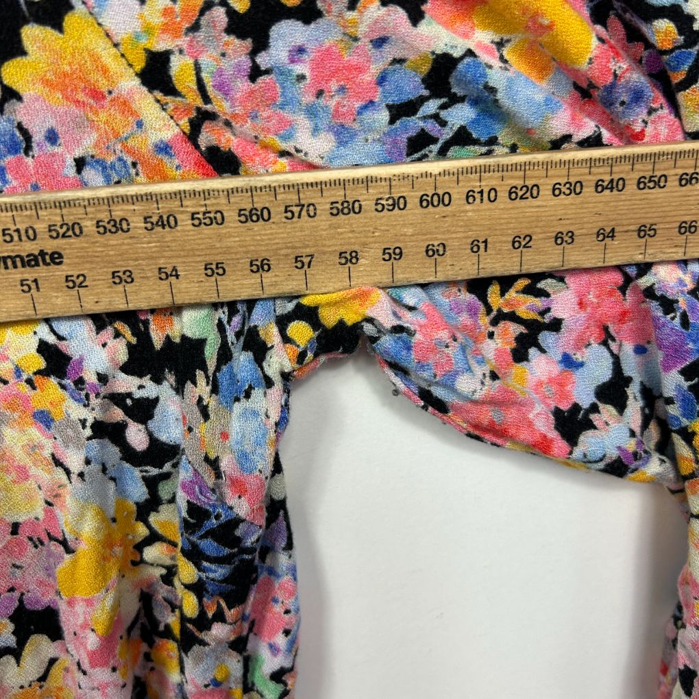 Colourful floral fabric detail view with measuring tape