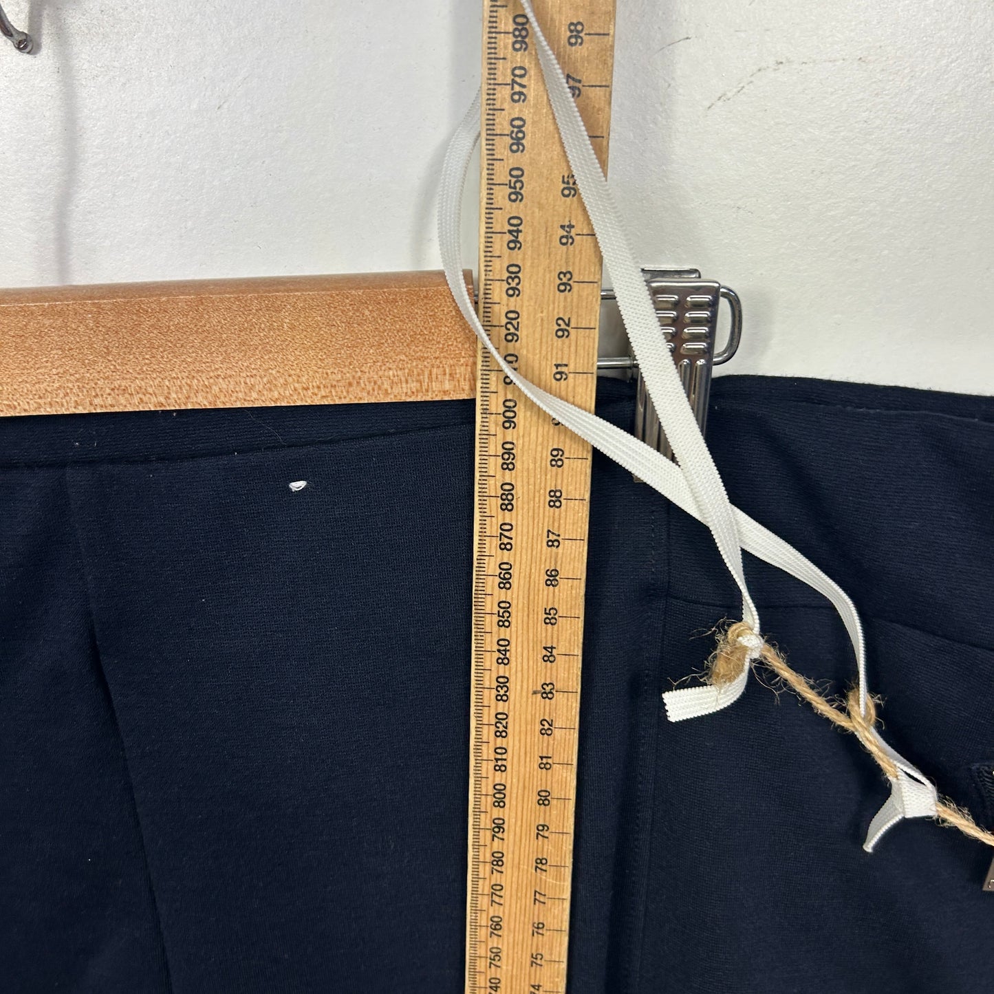 Navy blue pants with measuring tape detail view