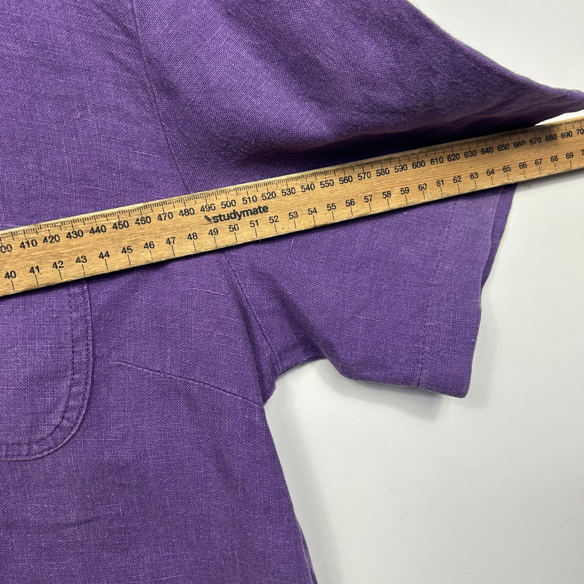 Purple shirt sleeve detail view with measurement tape