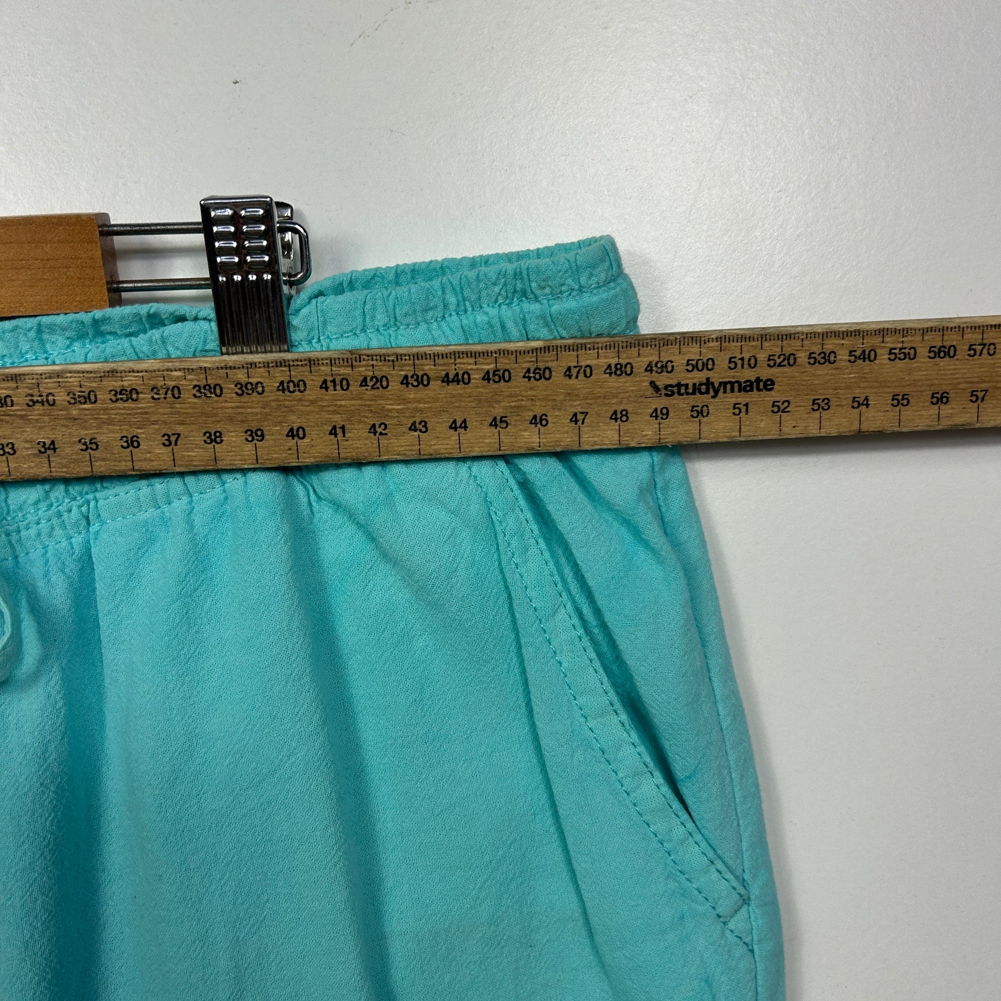 Turquoise shorts waistband detail view