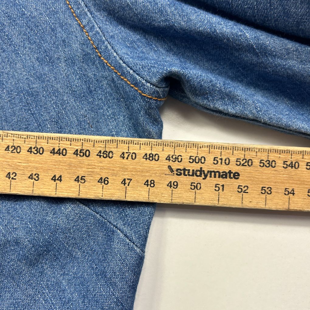 Blue denim fabric detail view with measuring ruler
