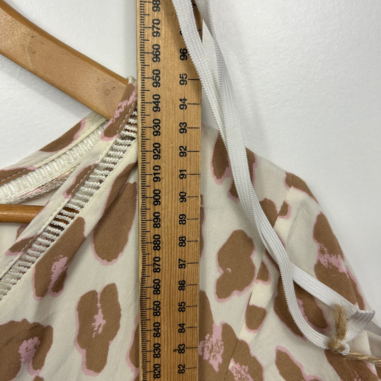 Cream and brown leopard print dress detail view with measuring tape