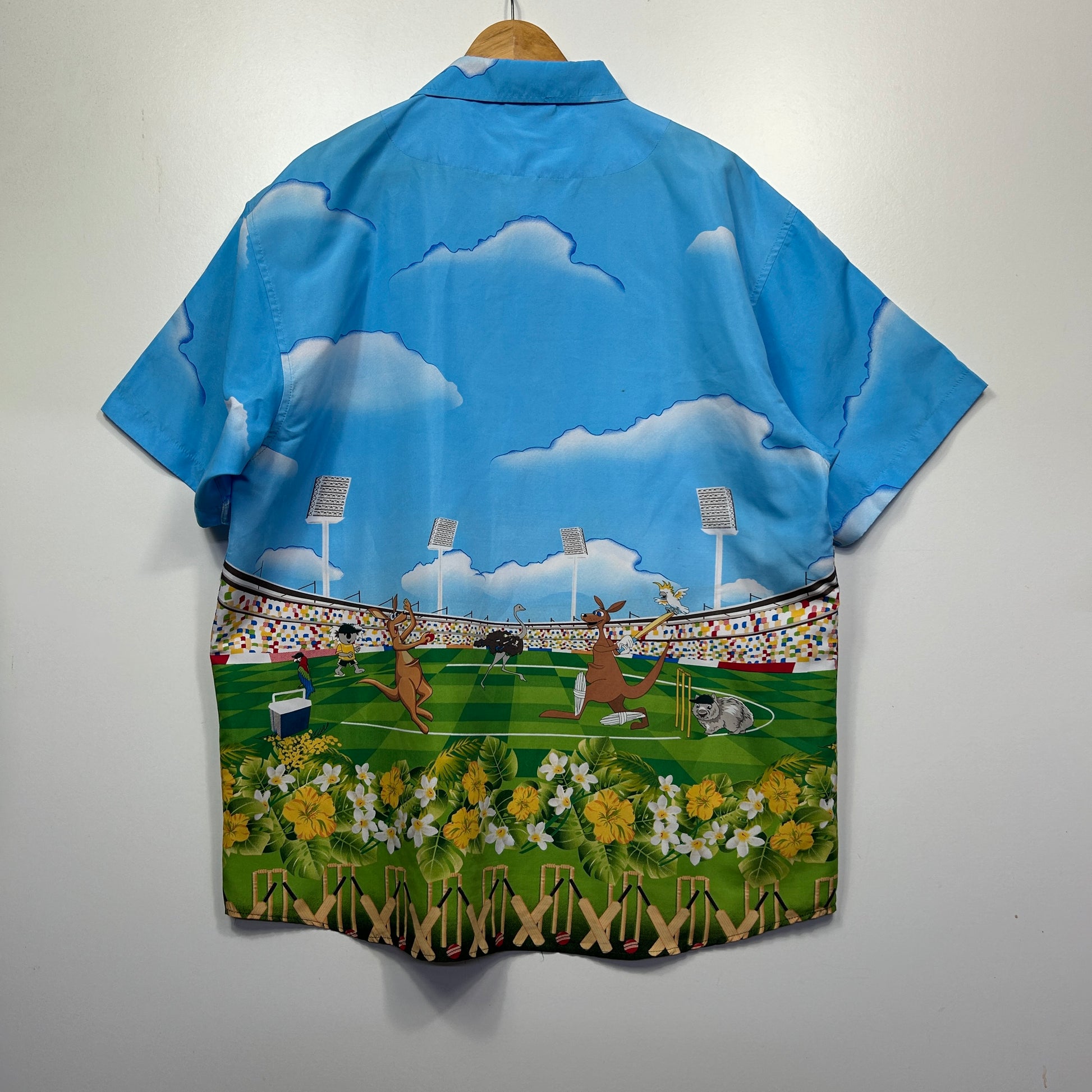 Blue short sleeve shirt back view with cloud and baseball field graphic print