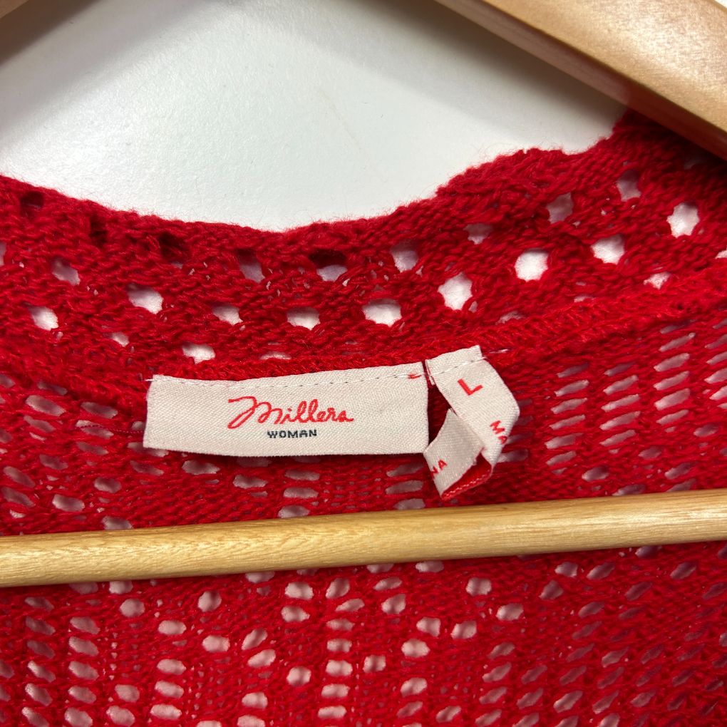 Red knit sweater detail view showing label