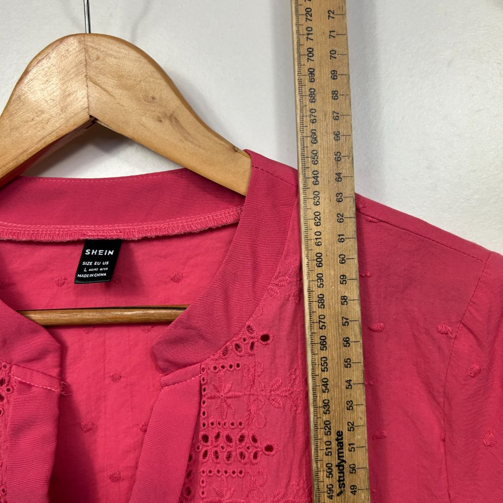 Hot pink top front view with decorative beading detail