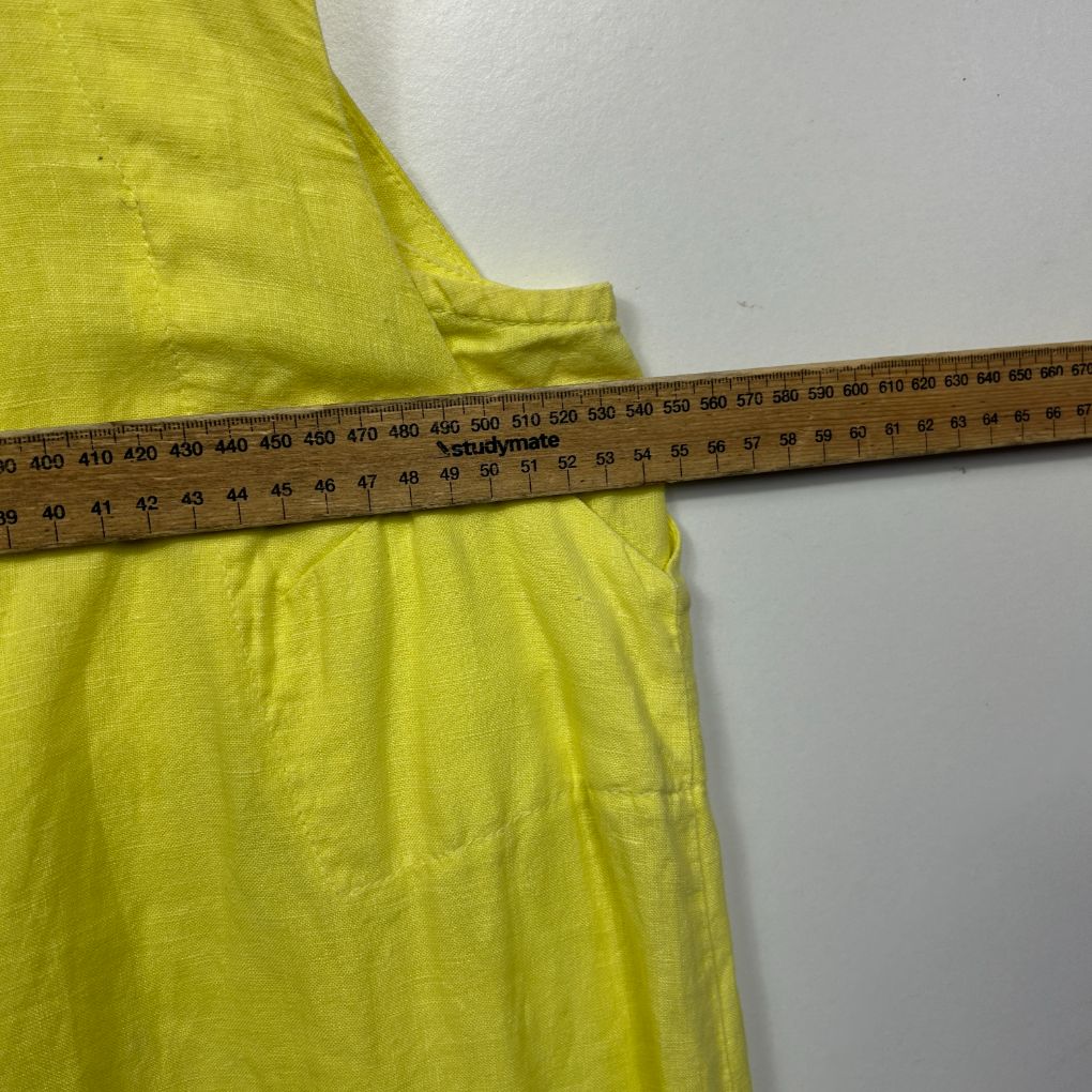 Yellow dress detail view with measurement tape