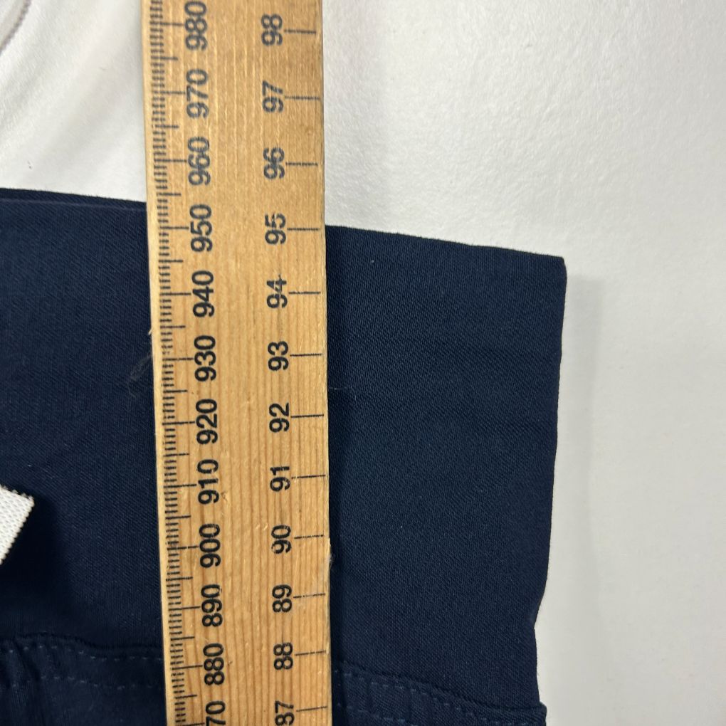 Navy blue fabric measured against ruler detail view