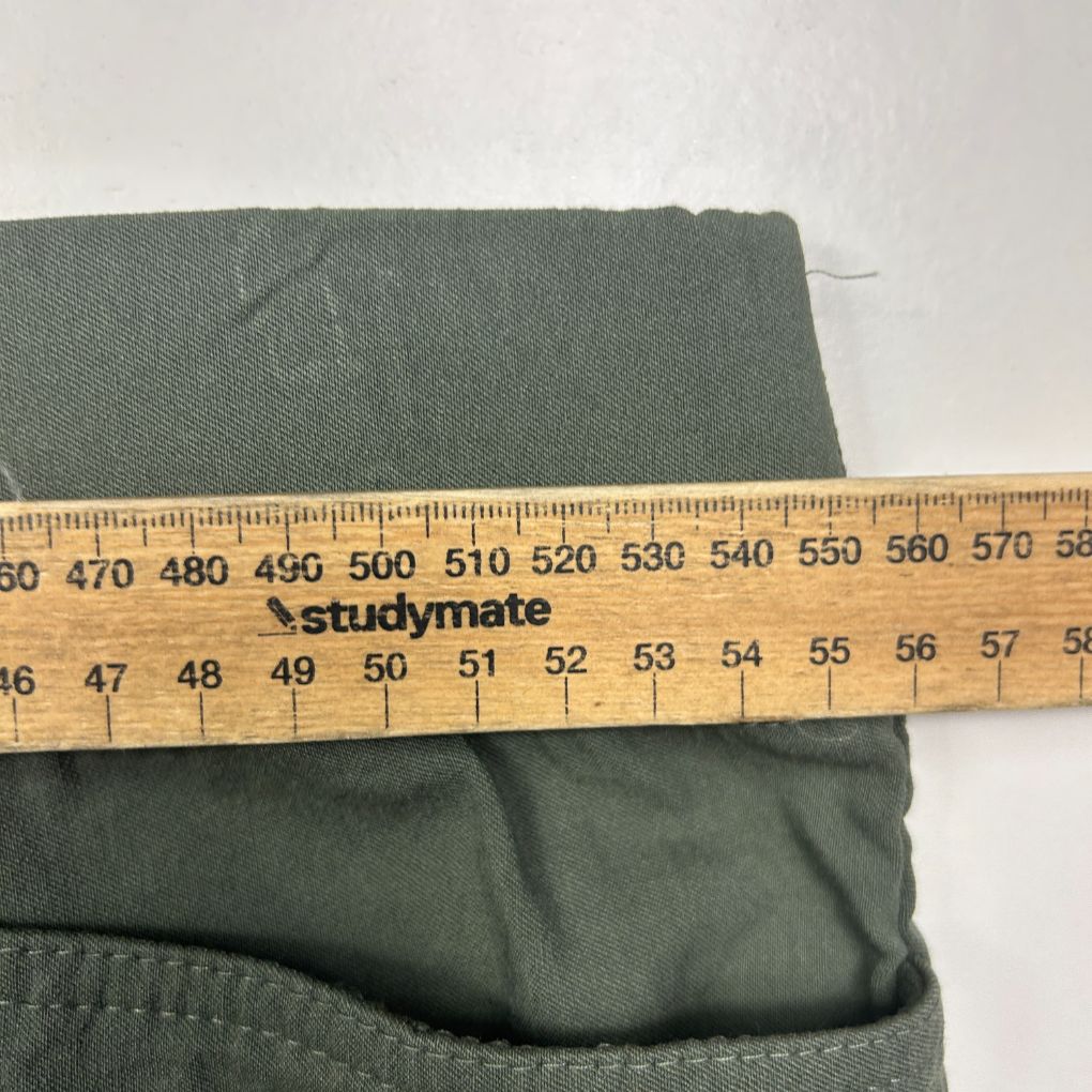 Green fabric detail view with measurement ruler