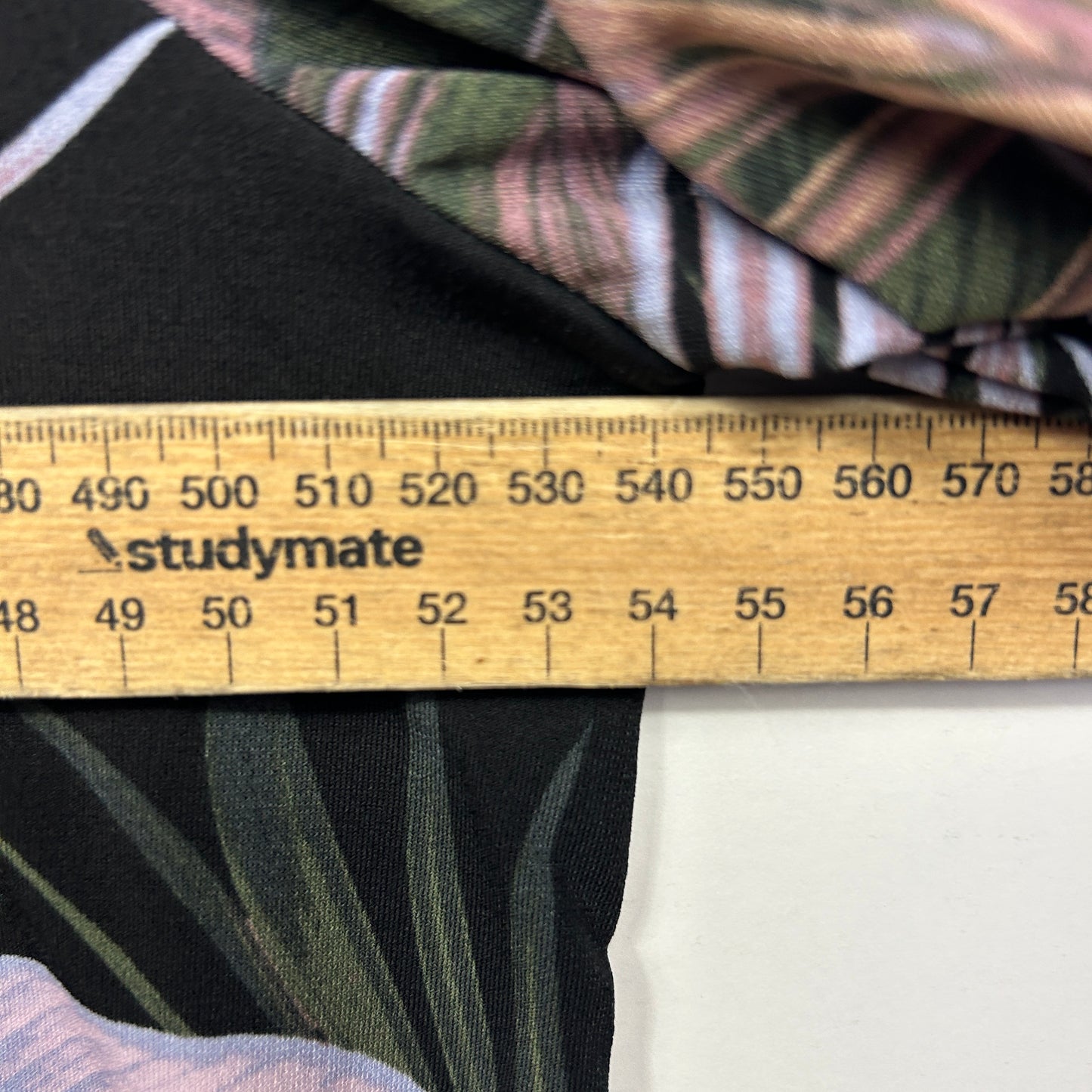 Black and green striped fabric detail view with measurement ruler