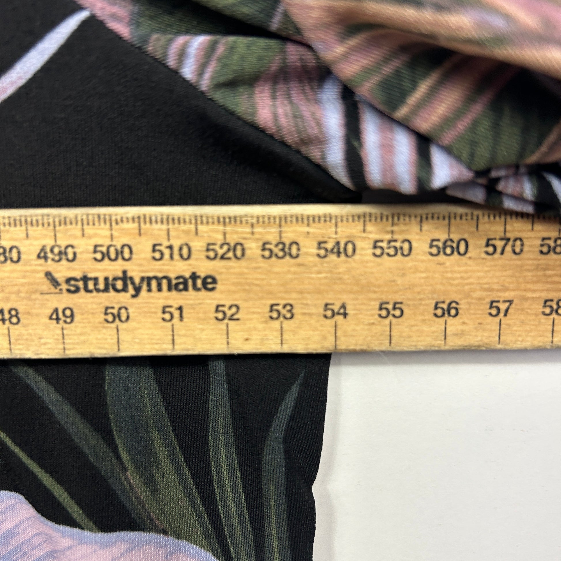 Black and green striped fabric detail view with measurement ruler