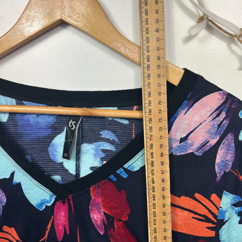 Colorful floral print shorts detail view with measuring tape