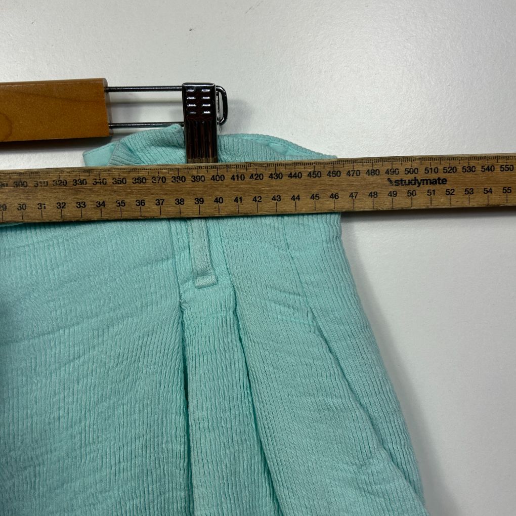 Turquoise ribbed shorts detail view with measuring tape
