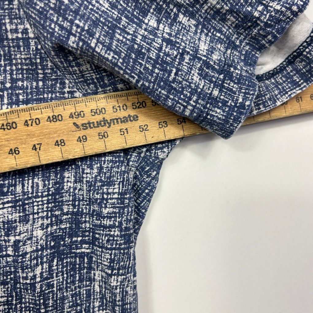 Navy blue textured fabric with measuring tape detail view