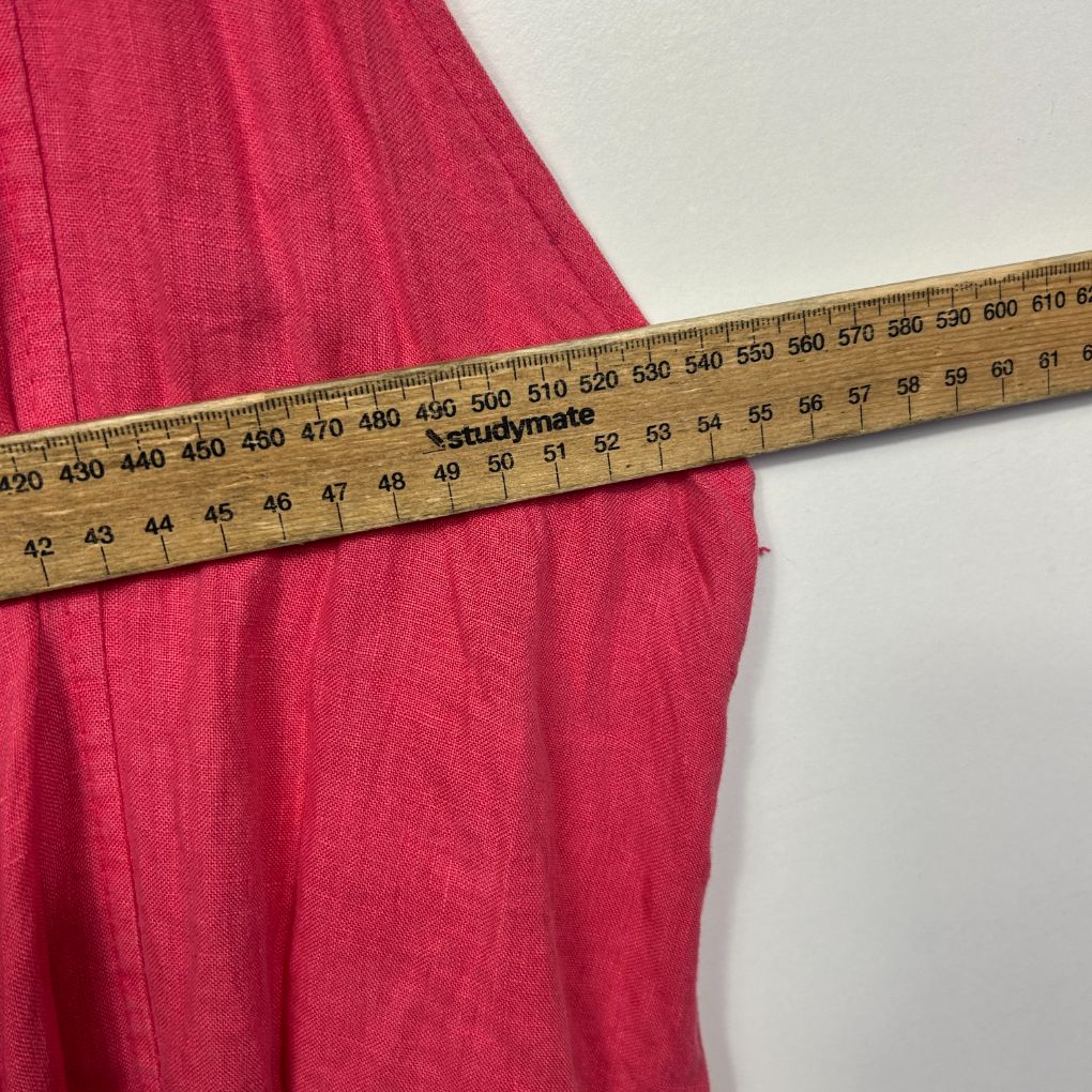 Pink fabric measured with tape measure detail view