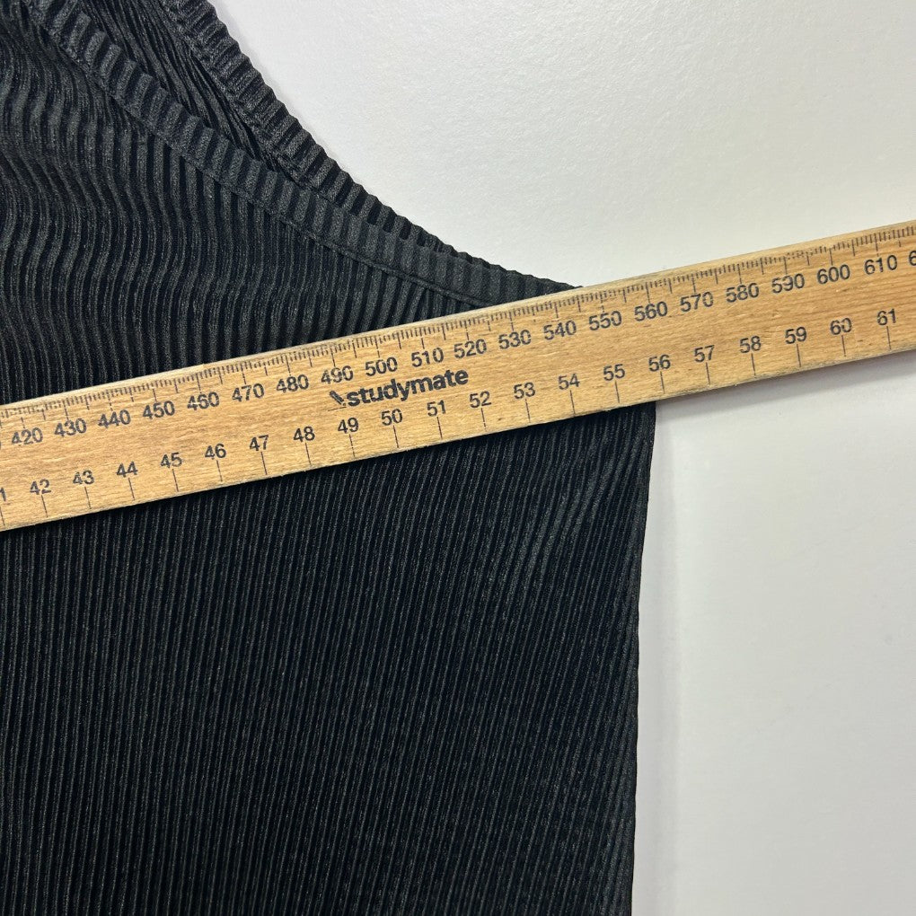 Black ribbed knit top detail view with measuring tape