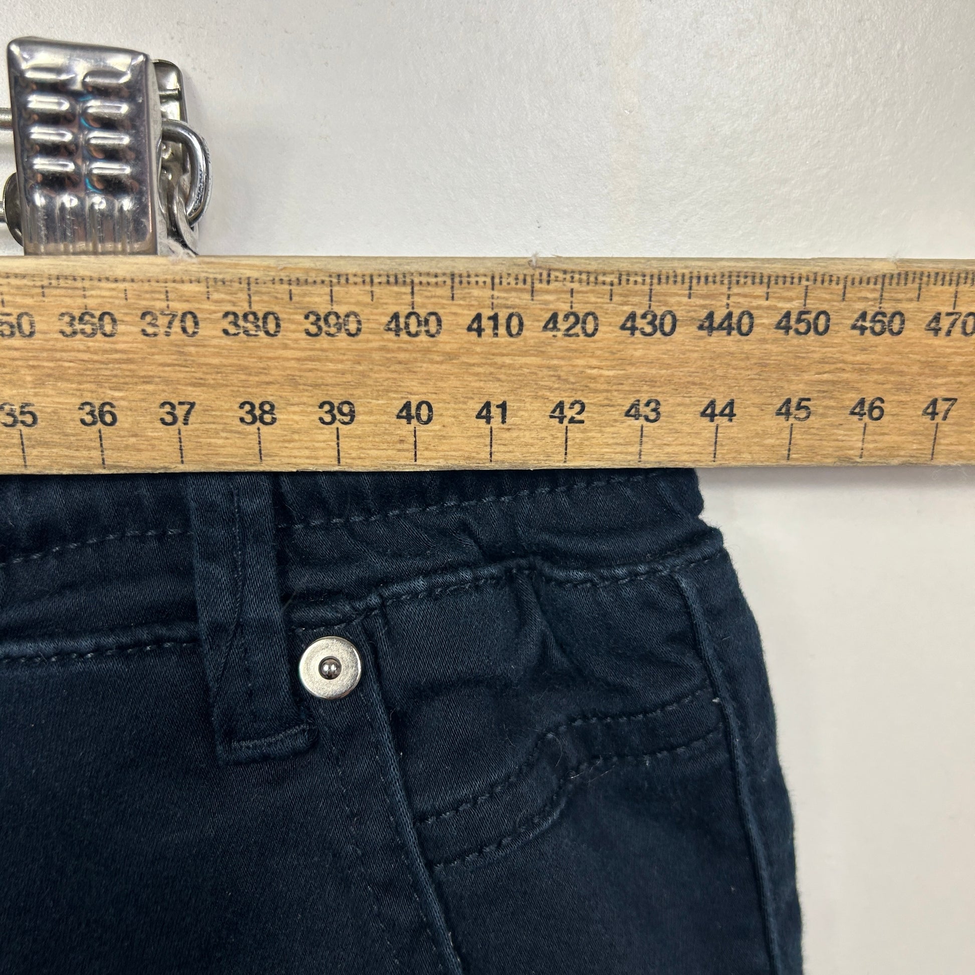 Navy blue jeans with ruler measurement detail view