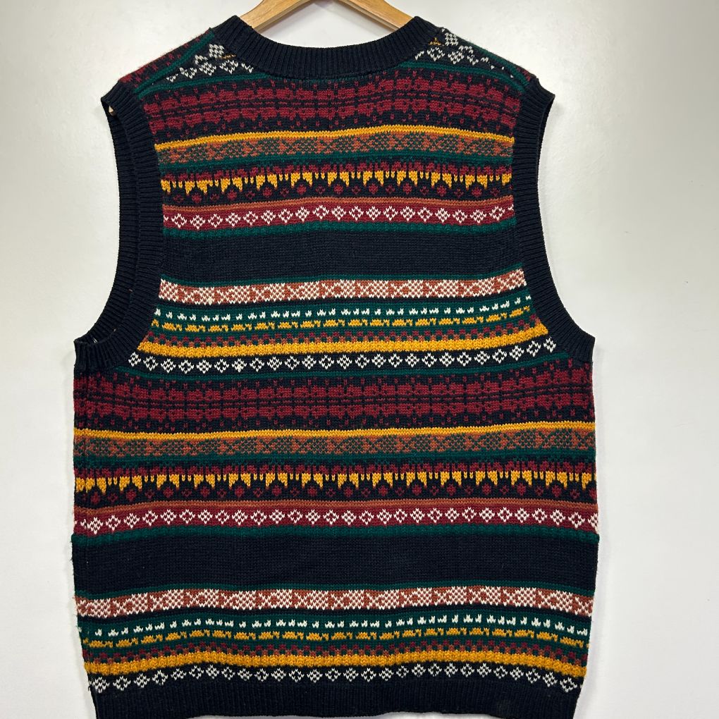 Navy sleeveless sweater vest front view with multicoloured geometric and fair isle striped pattern