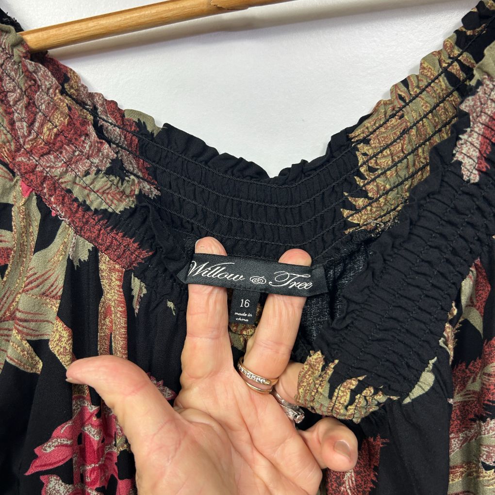 Black floral top detail view showing elastic waistband