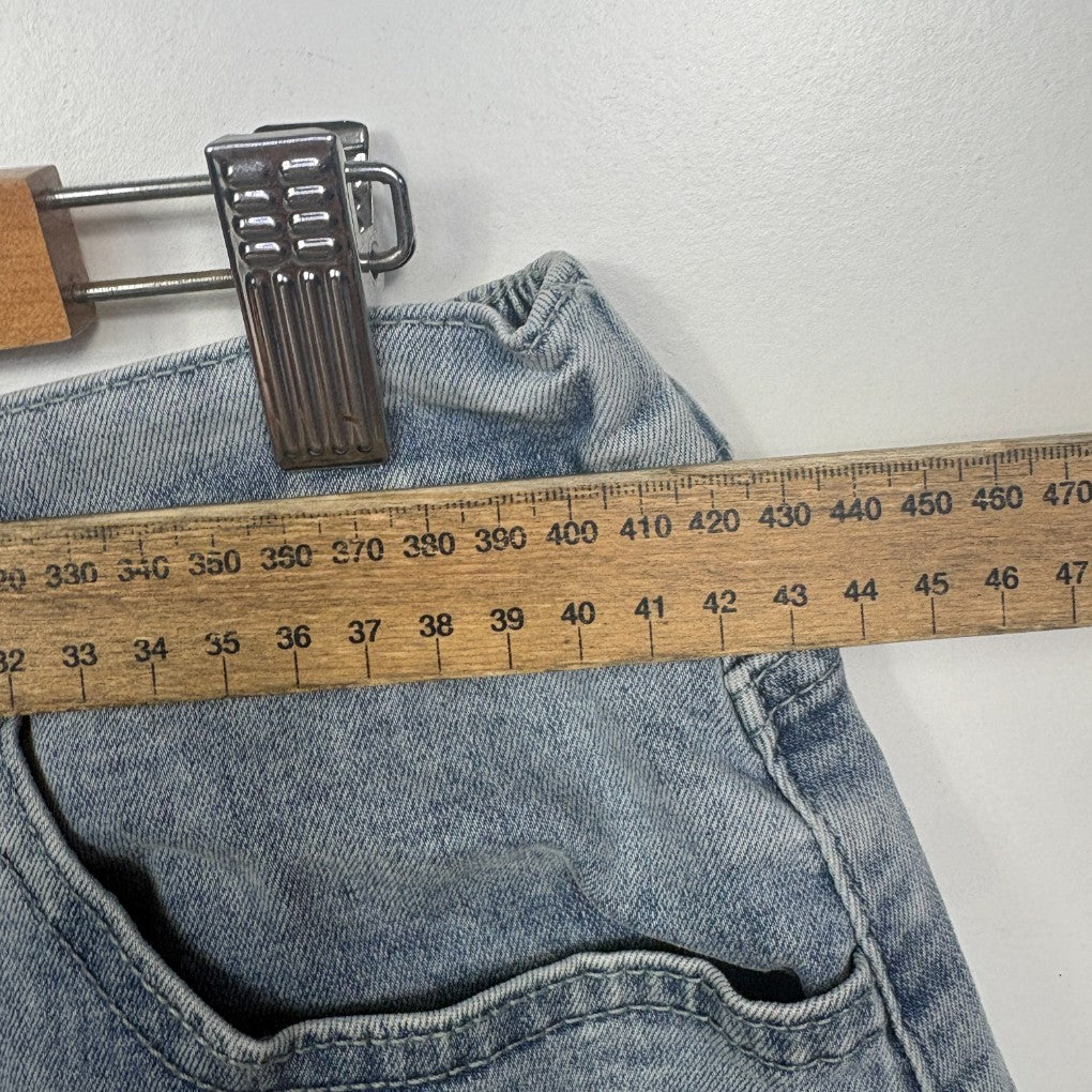 Light blue denim jeans with measuring tape and belt detail view