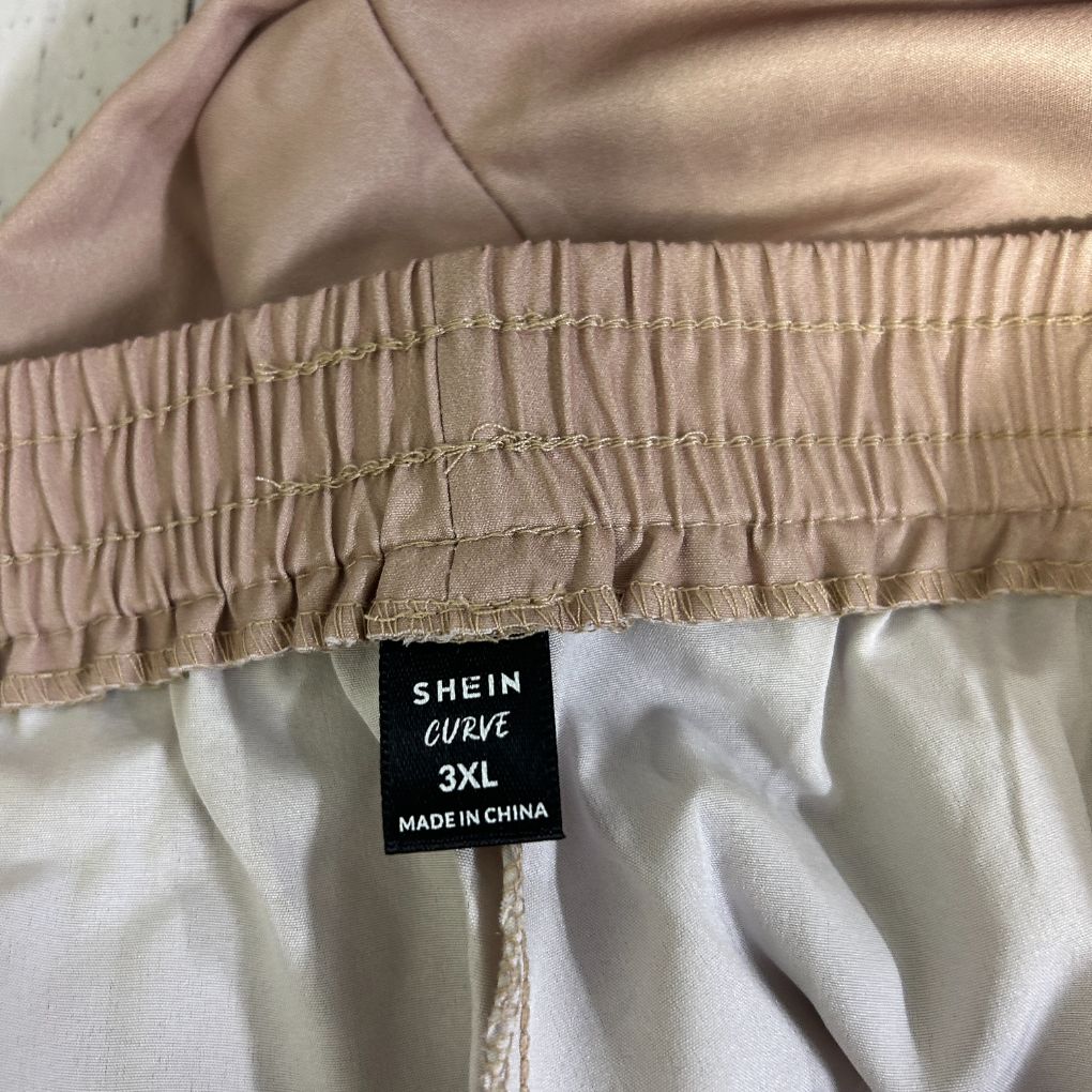 Beige pants detail view showing elastic waistband and size label