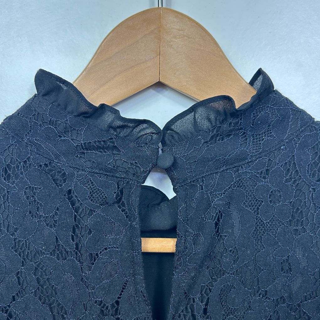 Navy lace top back view on wooden hanger