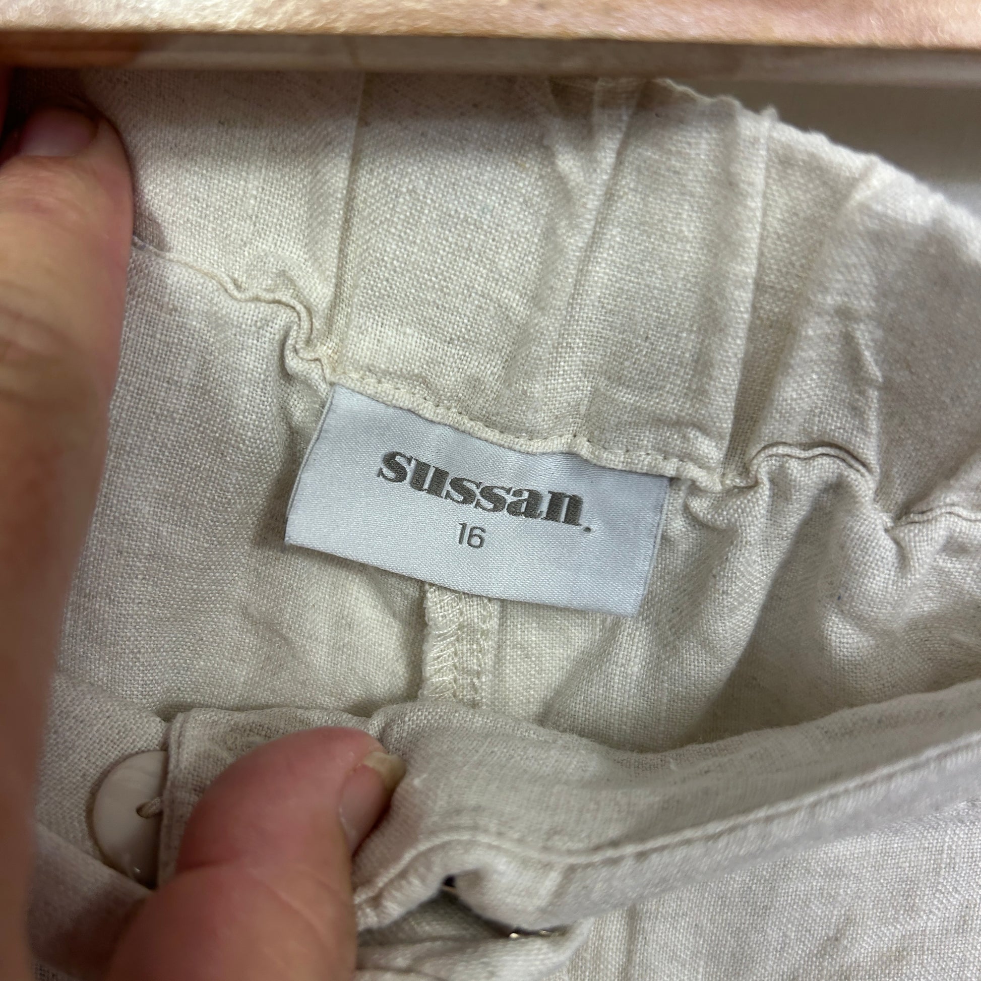 Cream linen garment label detail view