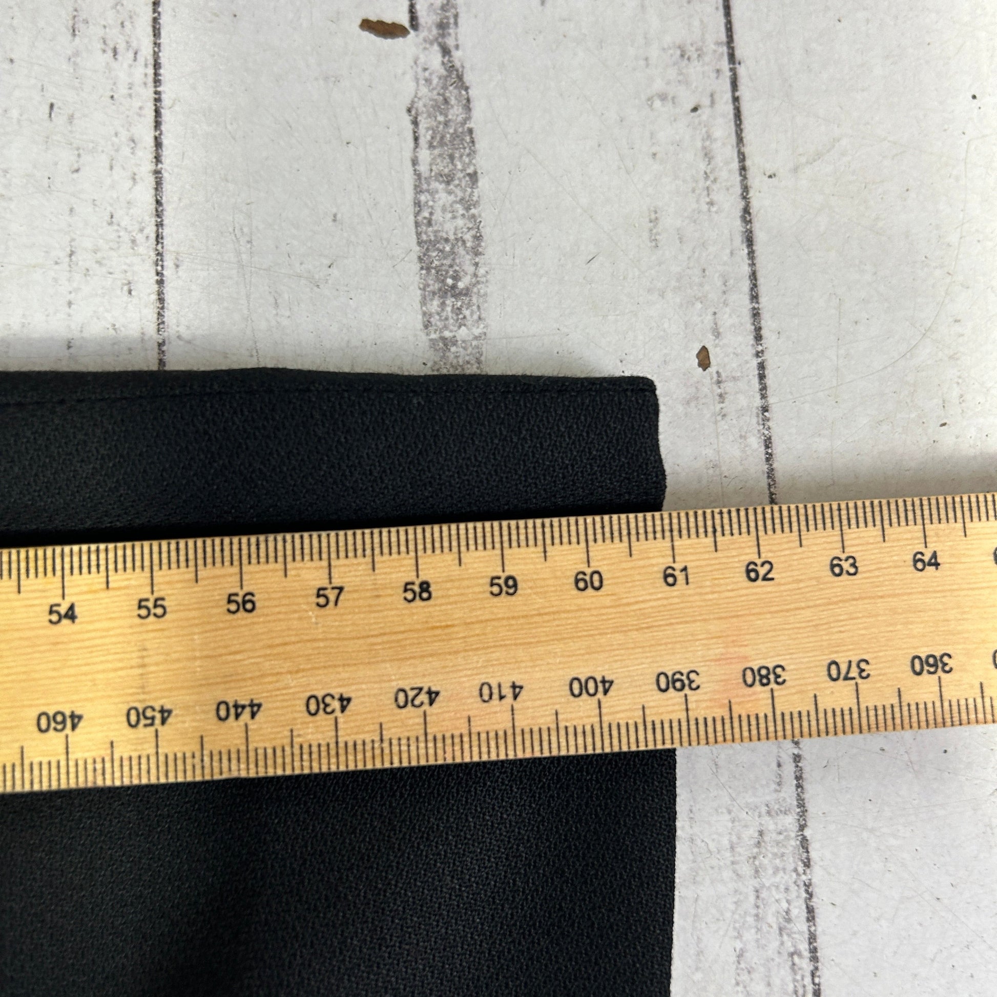 Black elastic band detail view with measuring tape
