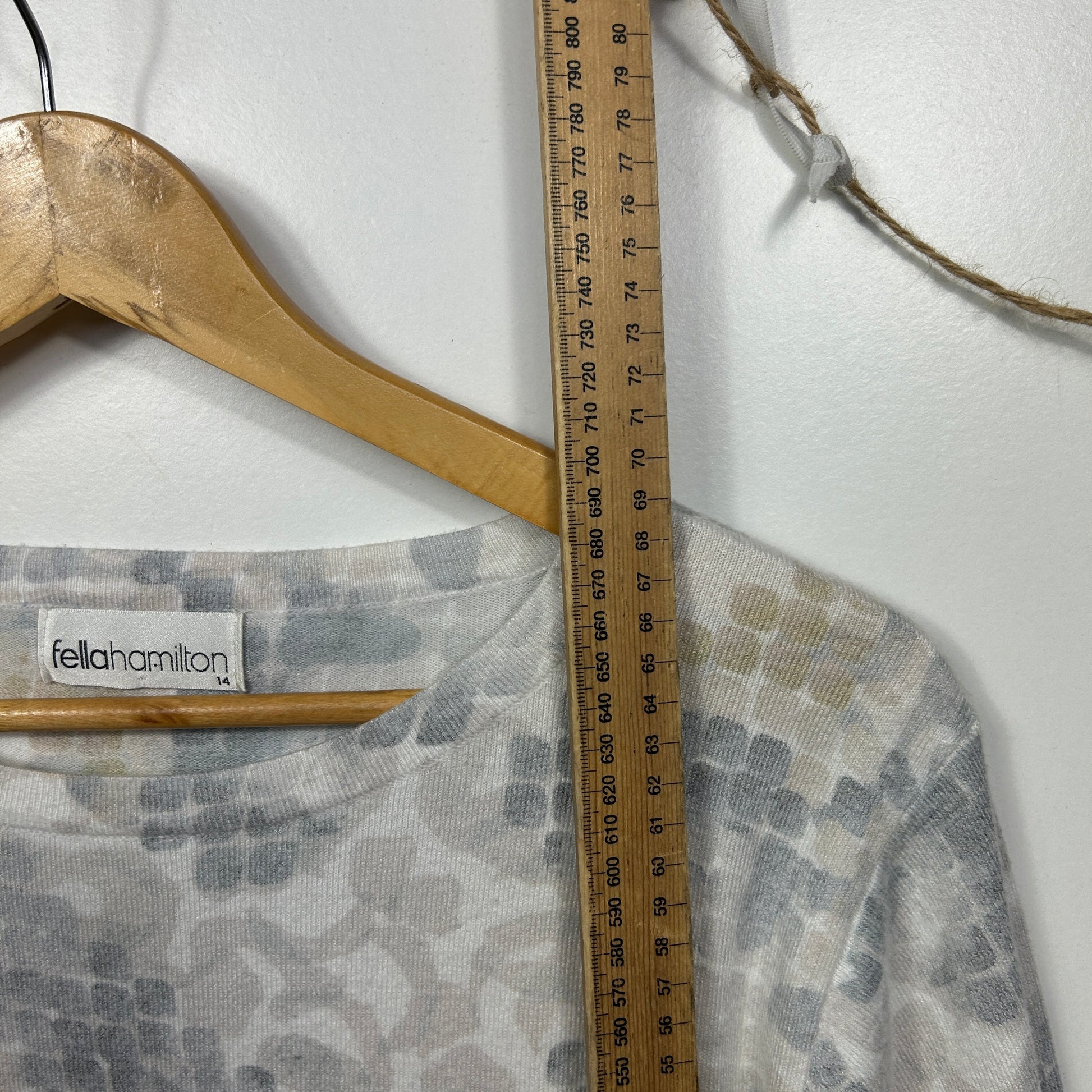 Grey patterned long sleeve top front view with measuring tape