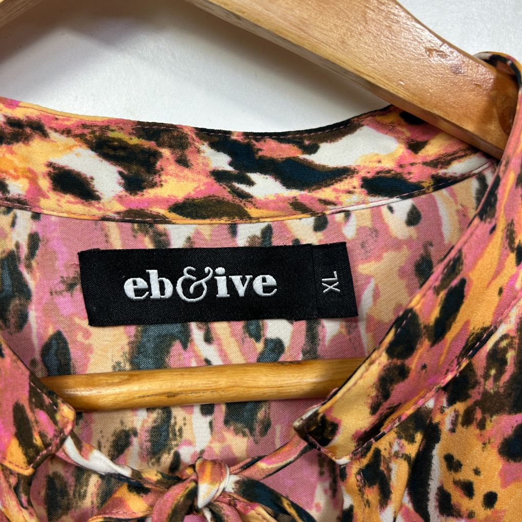 Pink and black animal print shirt label detail view