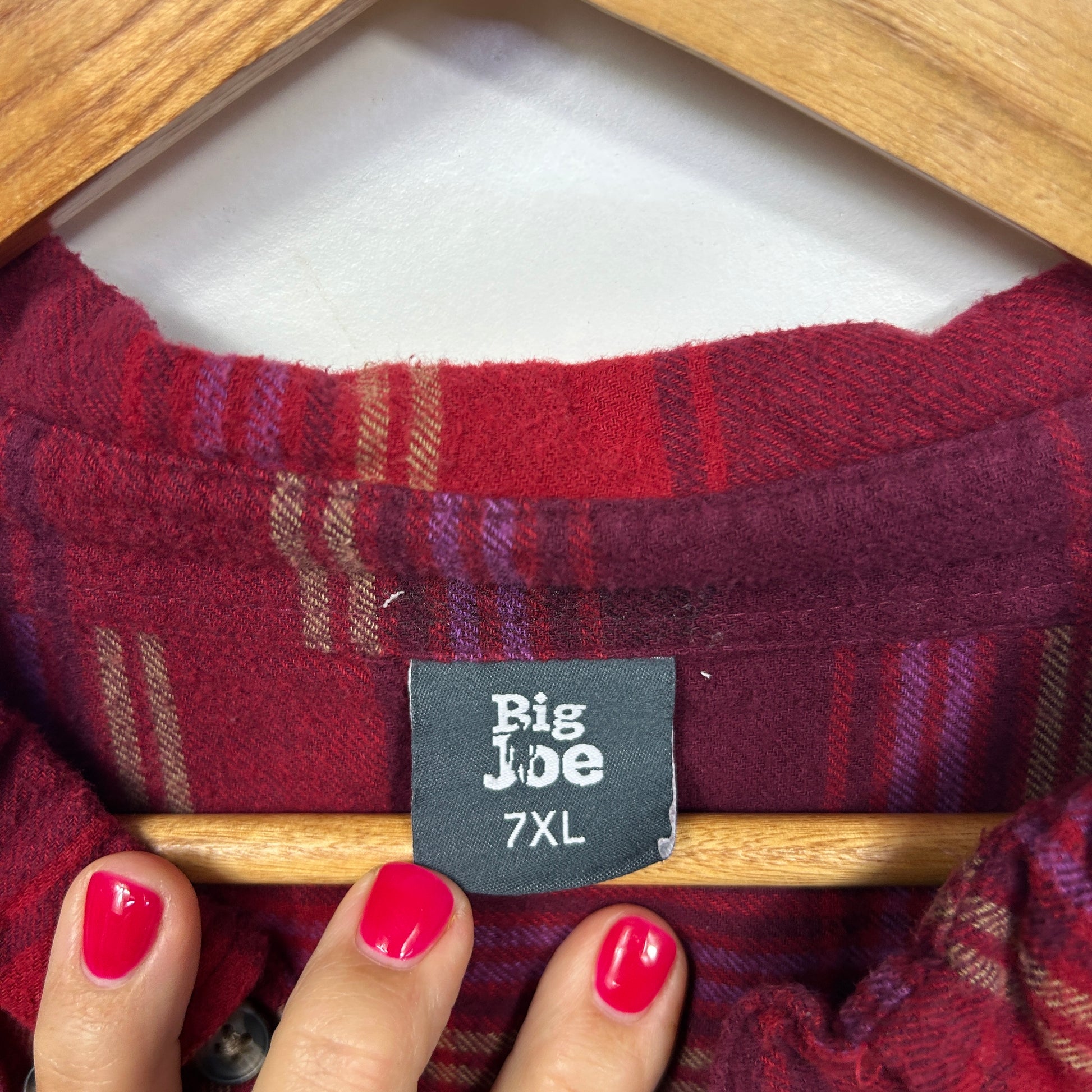 Red and burgundy plaid shirt label detail view