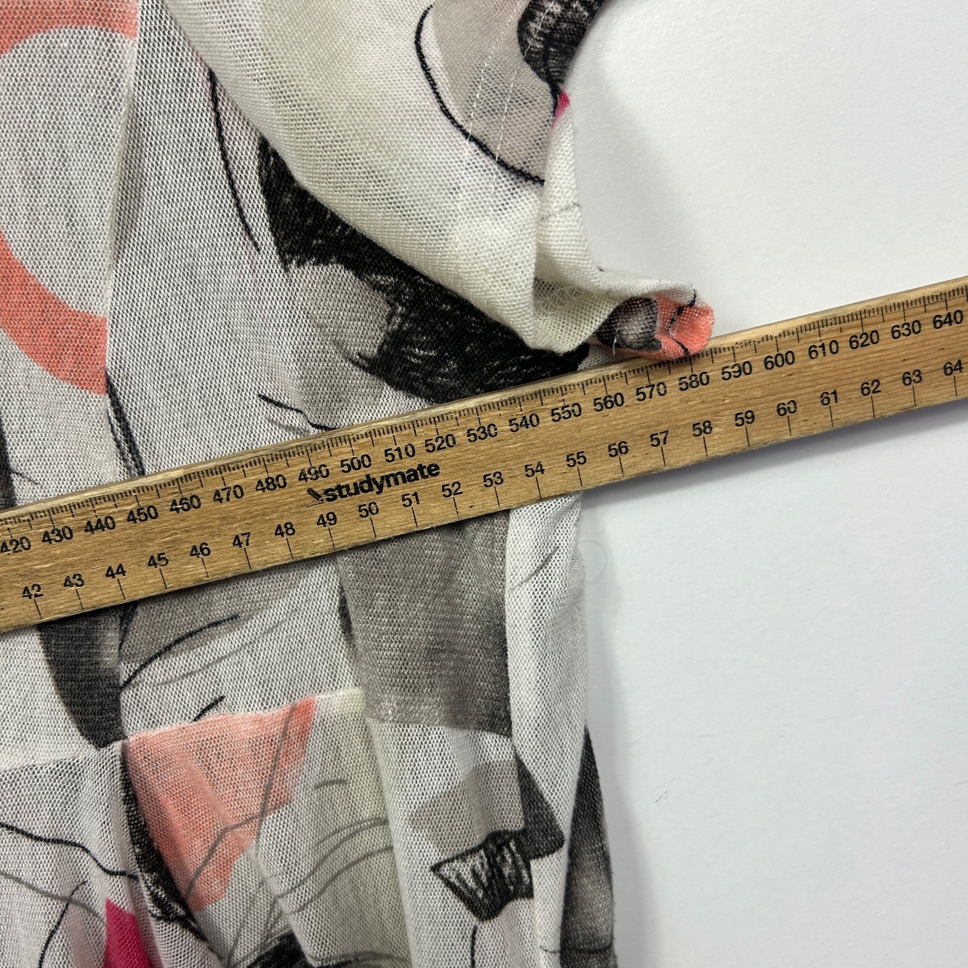 Cream and grey graphic print top detail view with measuring tape