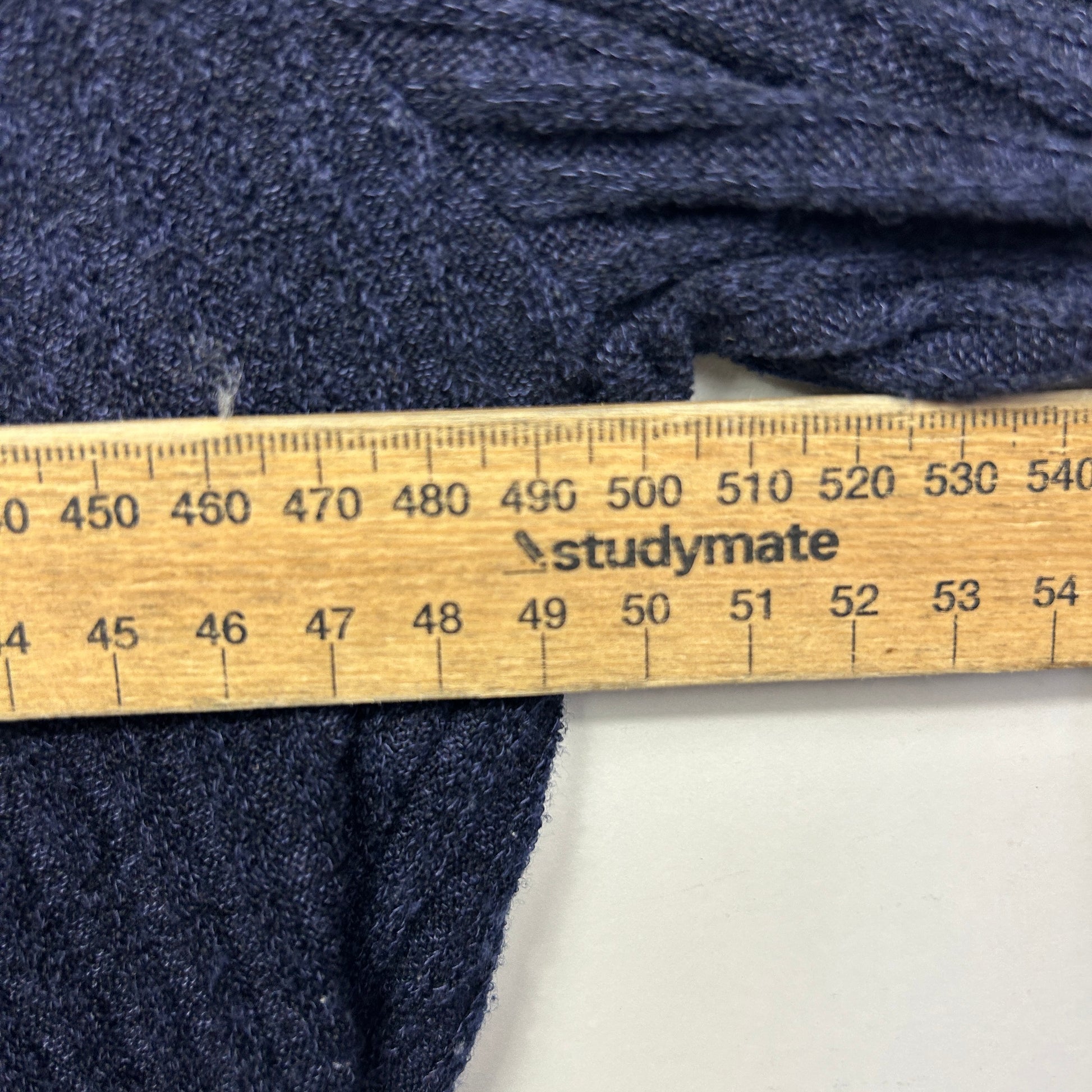 Navy knit fabric detail view with measuring ruler