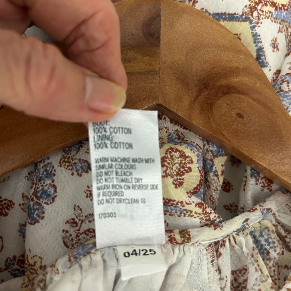 Cream floral dress label detail view