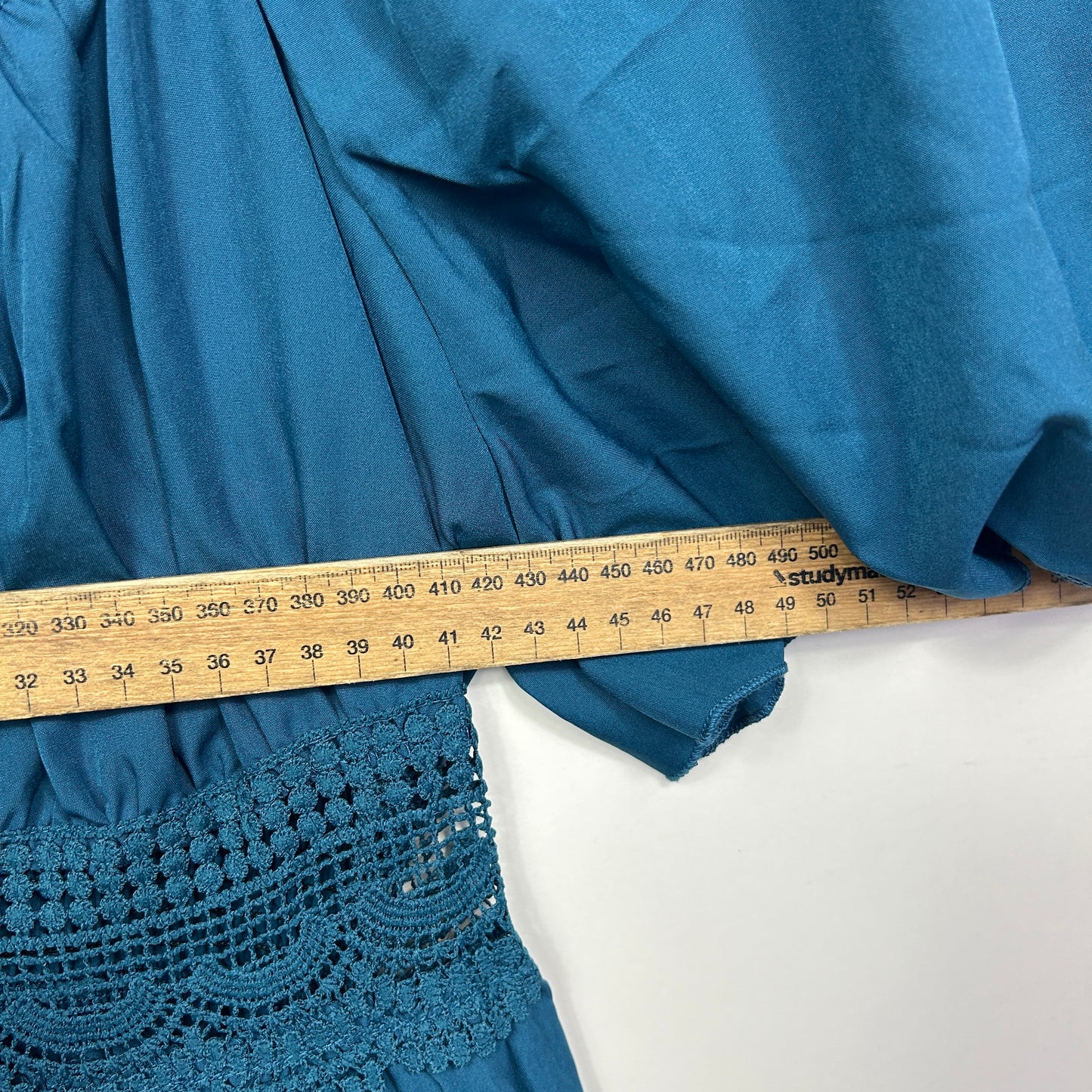 Blue jacket detail view with measuring tape