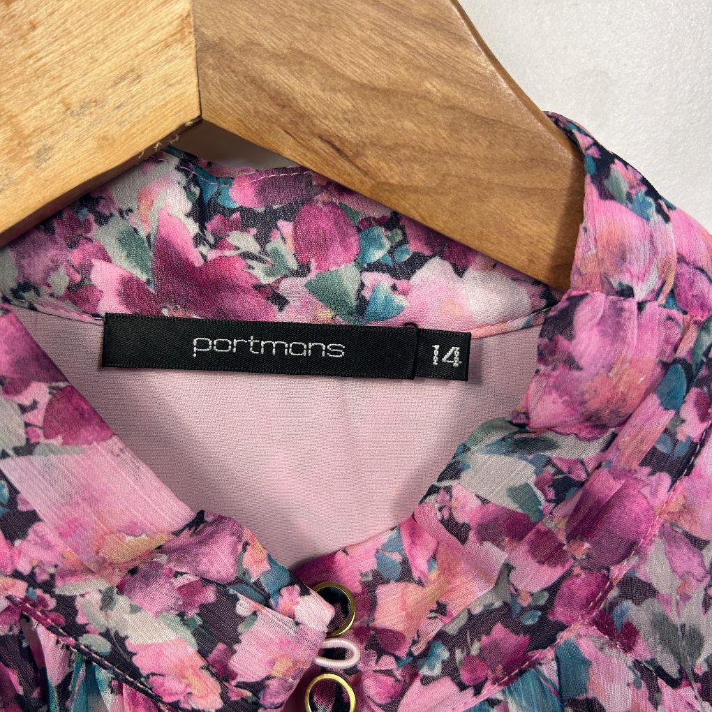 Pink floral top front view on wooden hanger