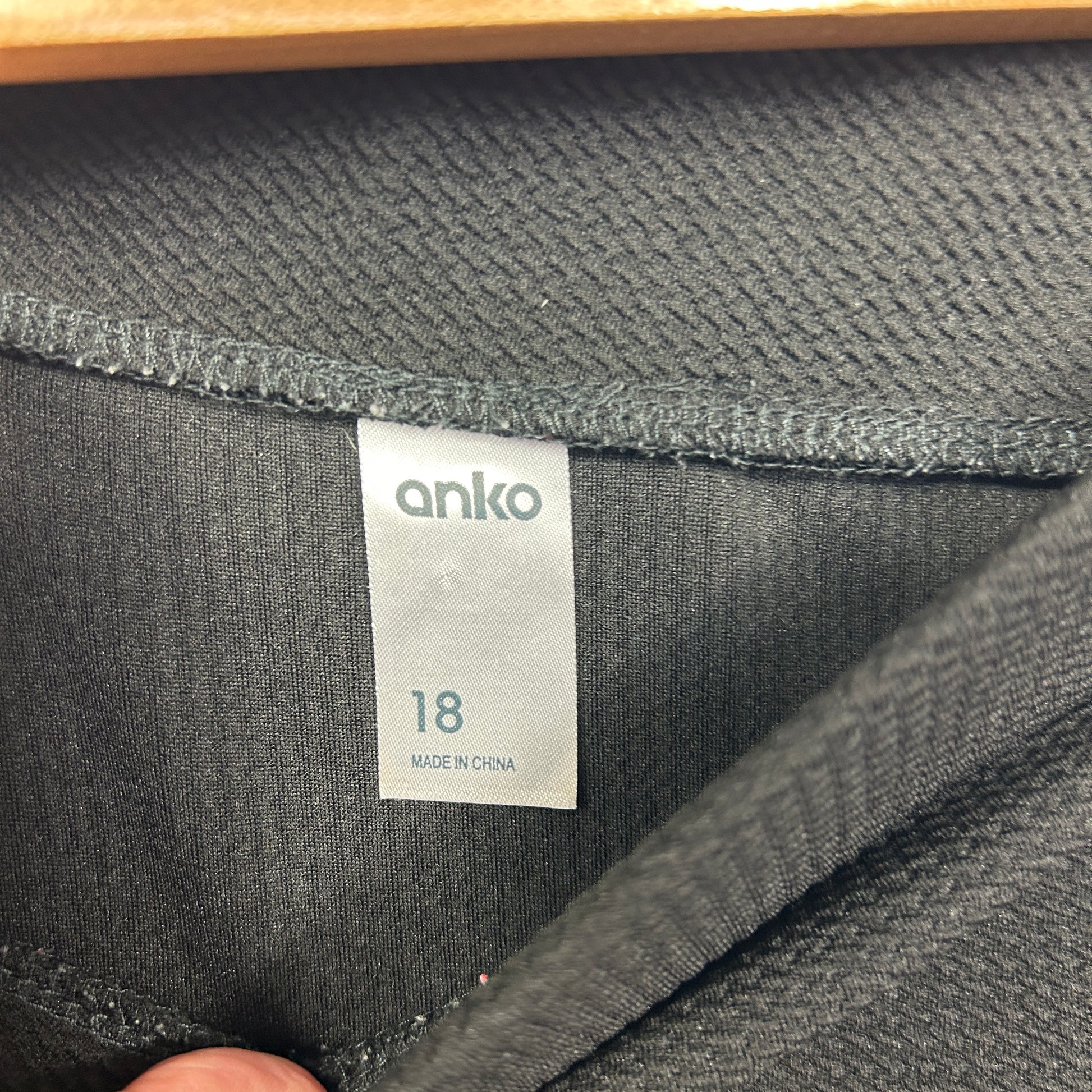 Black textured fabric detail view showing anko size 18 label