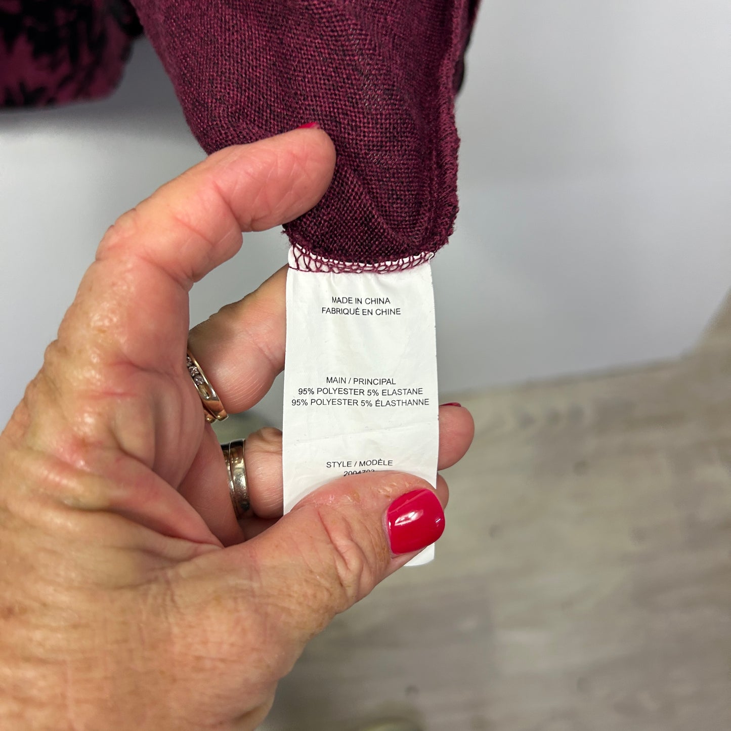 Burgundy sweater label detail view