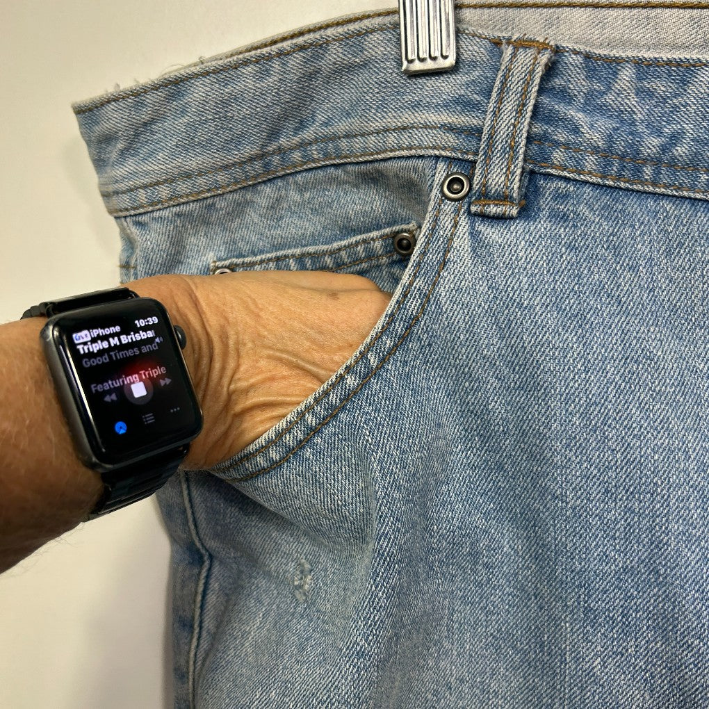 Light blue denim jeans front view with smartwatch detail