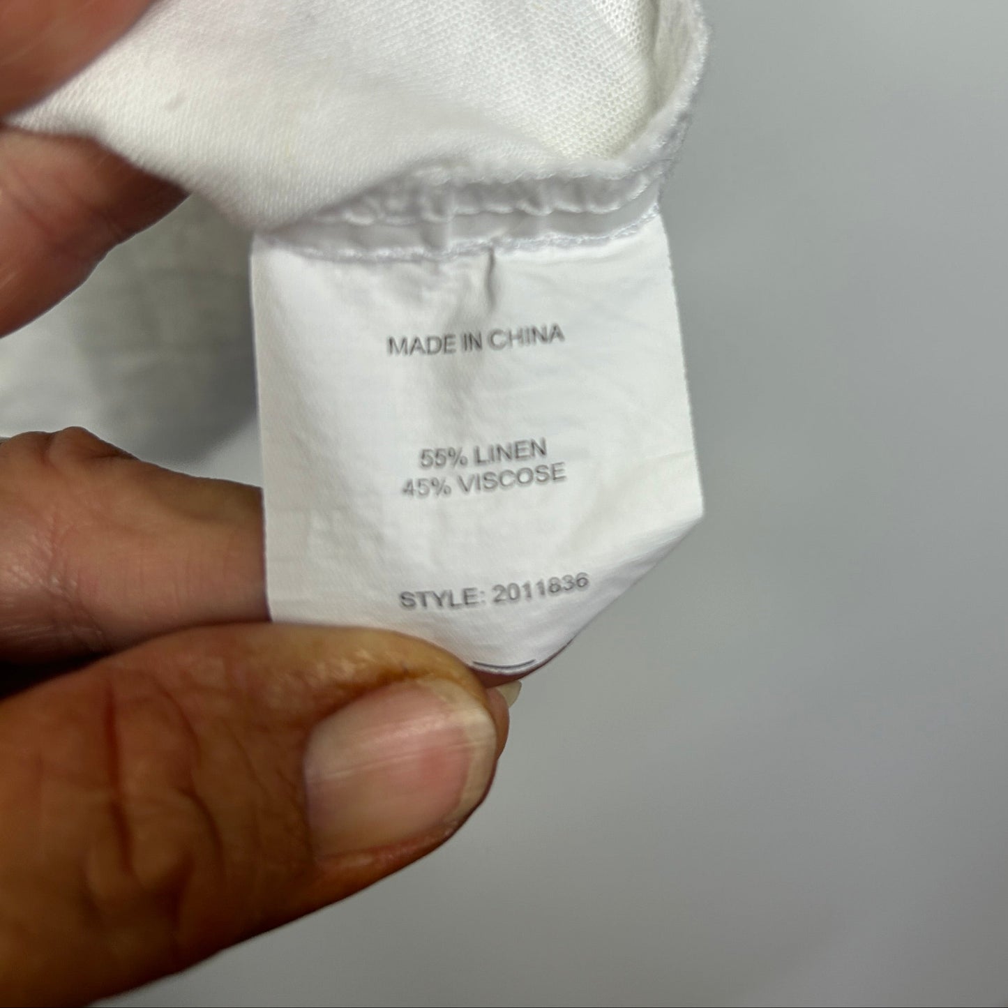 White linen garment label detail view
