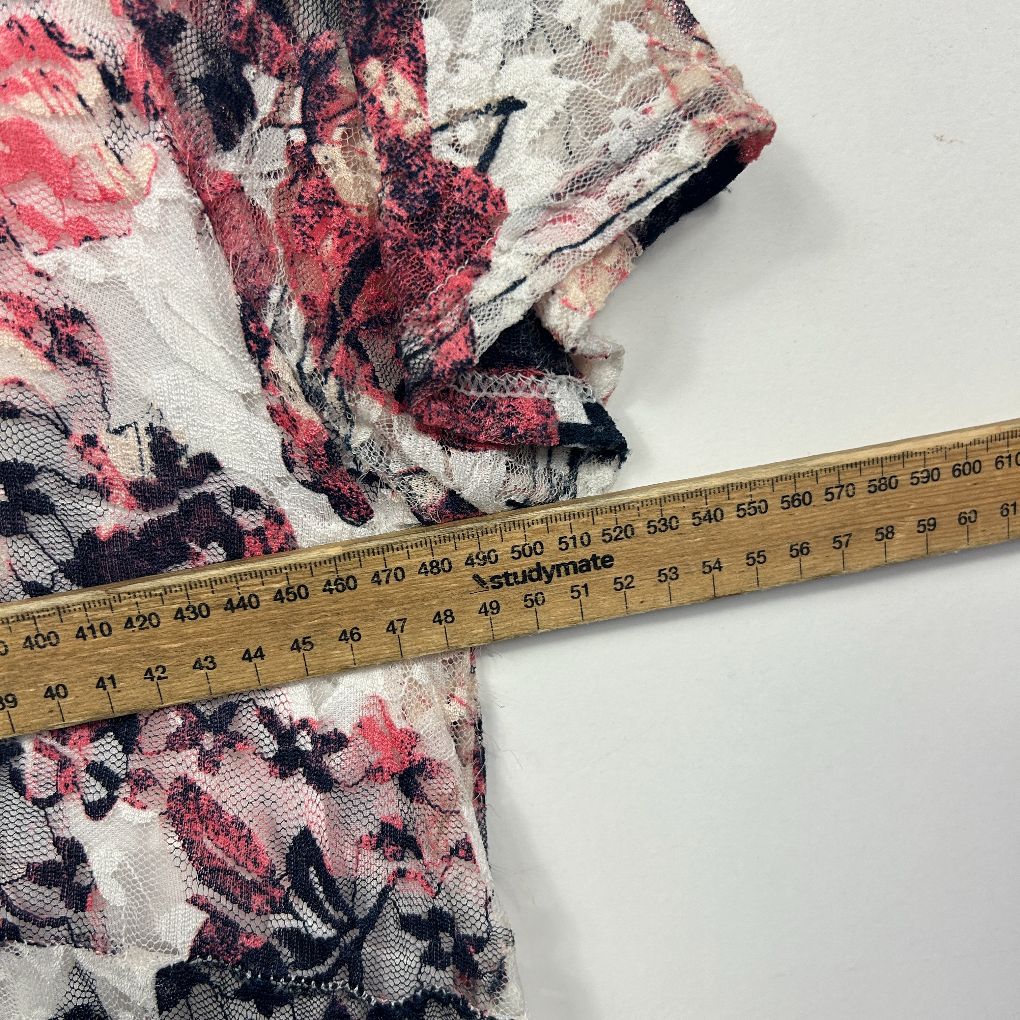 Pink and navy floral fabric detail view with measuring tape