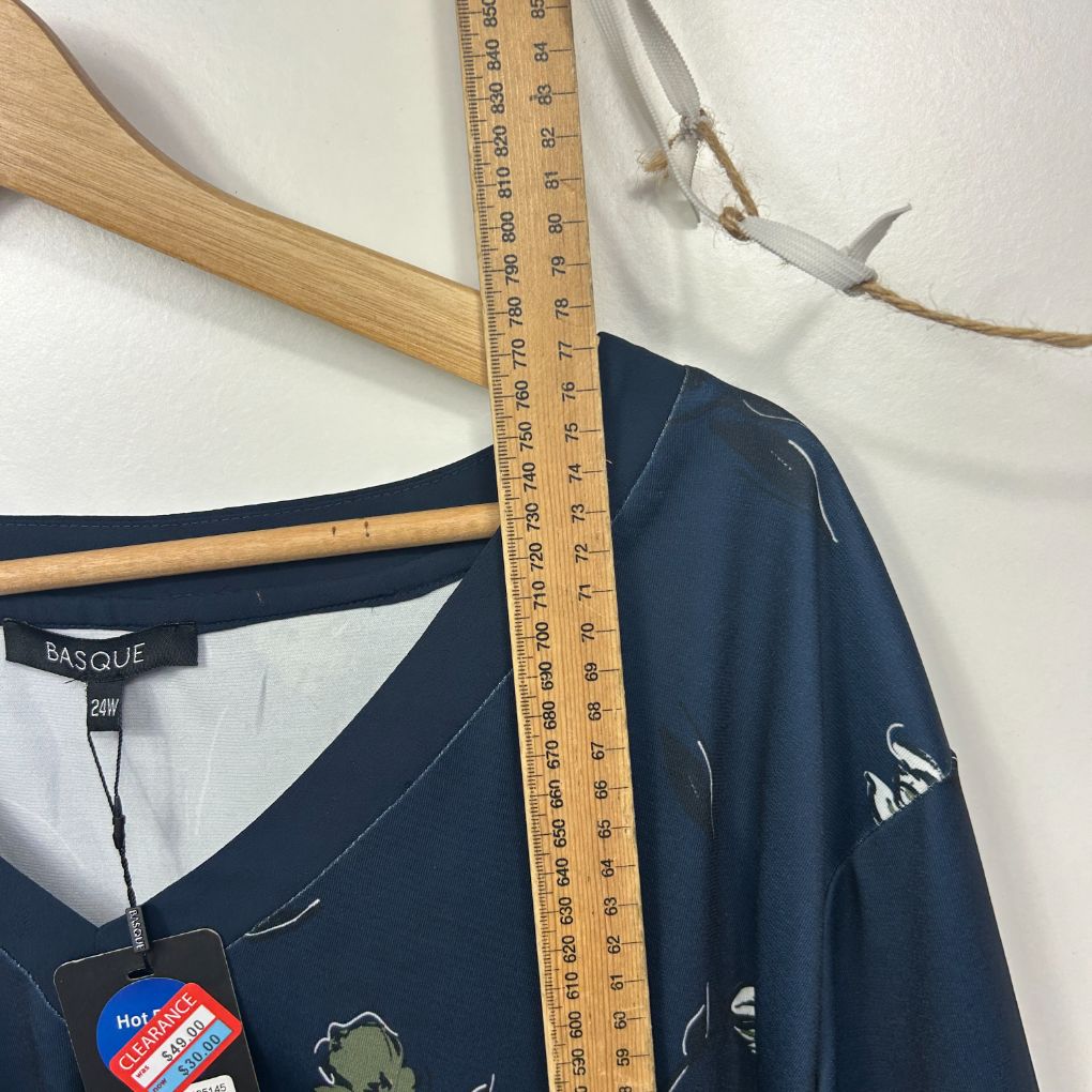 Navy blue long sleeve top front view with measuring tape