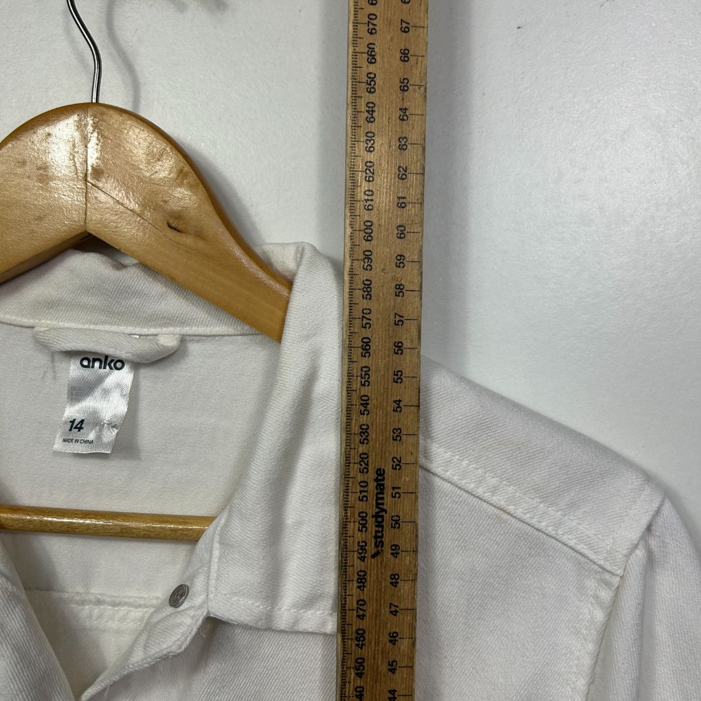 White shirt front view on wooden hanger with measuring tape