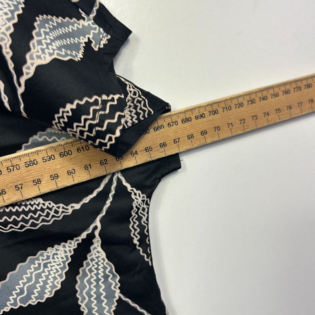 Black top with white geometric pattern detail view