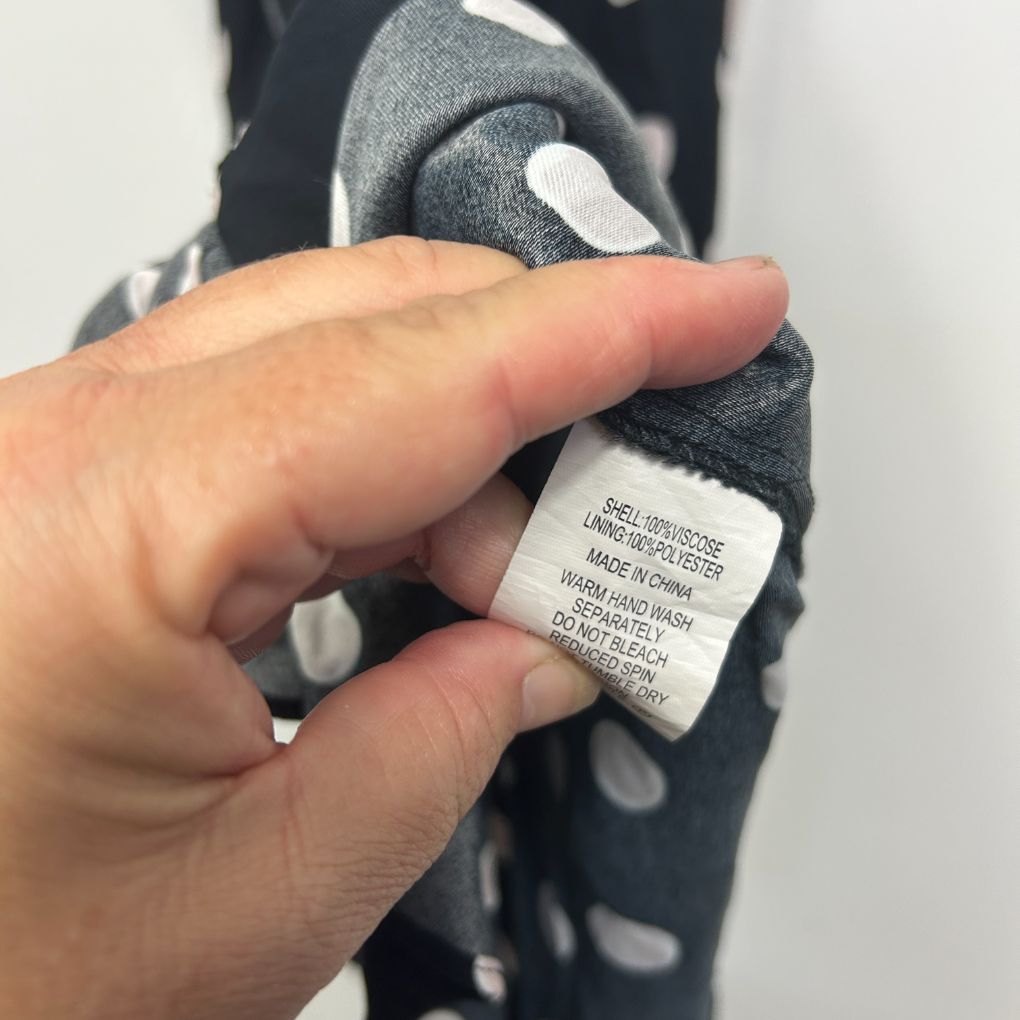 Navy and white polka dot jumper label detail view