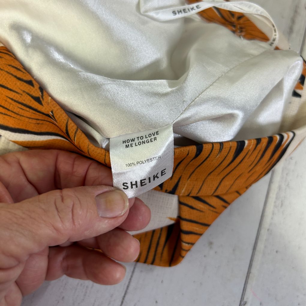 Orange striped shirt label detail view