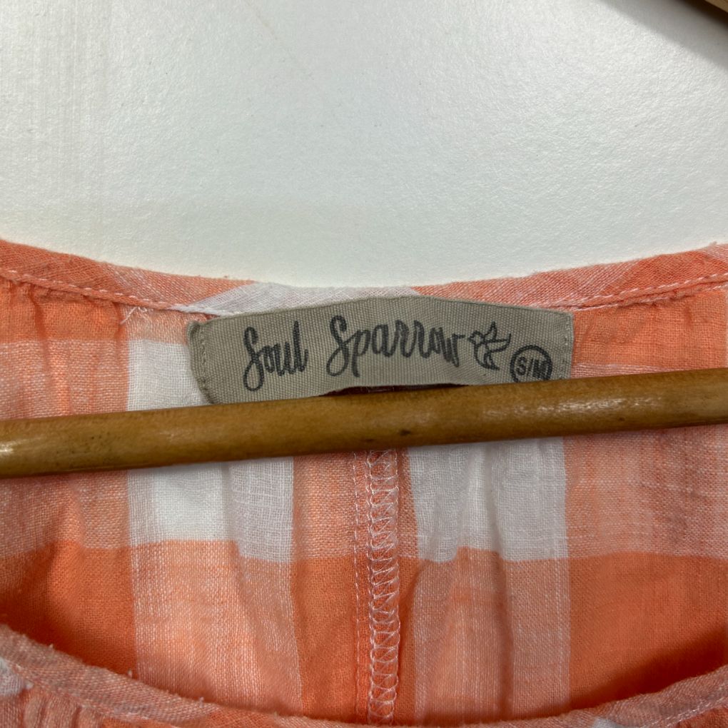 Orange and white striped shirt label detail