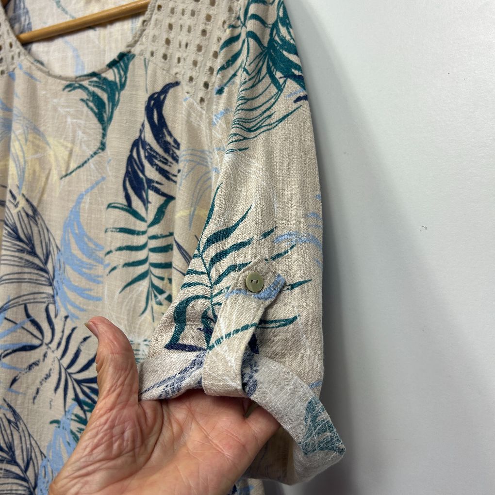 Beige linen shirt with teal and navy leaf print detail view