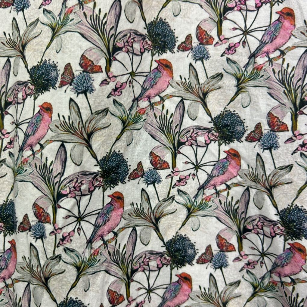 Cream fabric with floral and bird pattern detail view